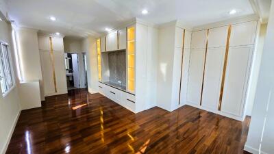 Spacious living room with hardwood floors and built-in cabinets