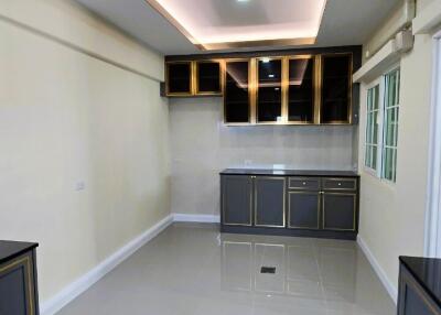 Modern kitchen with ambient lighting and glossy floor tiles