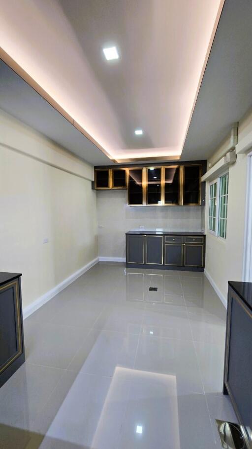 Modern kitchen with ambient lighting and glossy floor tiles