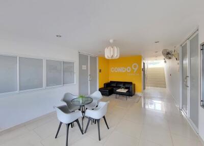 Spacious and modern living room with bright yellow accent wall and sleek furniture