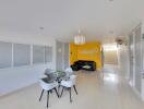 Spacious and modern living room with bright yellow accent wall and sleek furniture