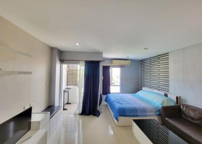 Modern bedroom with ample natural light and stylish interiors