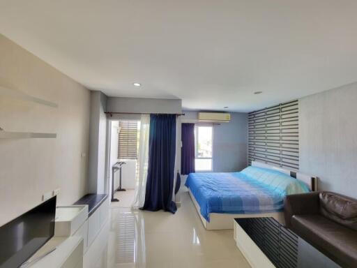 Modern bedroom with ample natural light and stylish interiors