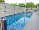 modern residential outdoor swimming pool with blue tiles