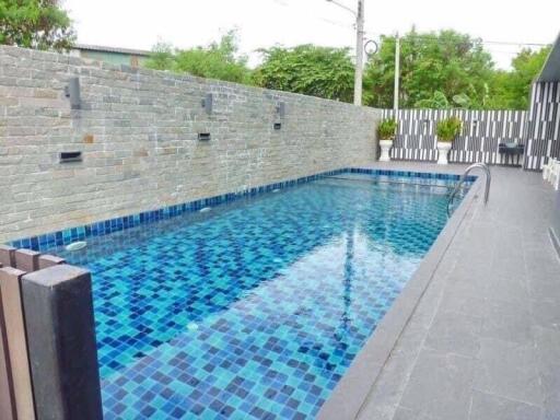 modern residential outdoor swimming pool with blue tiles
