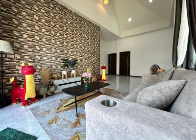 Spacious living room with stylish brick wall and modern decor