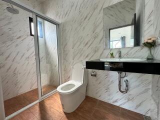 Modern bathroom with marble walls and walk-in shower