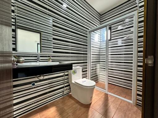 Modern bathroom with striped wallpaper and natural light