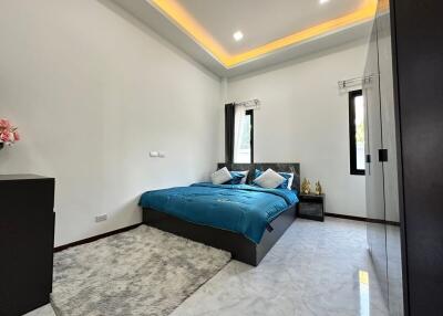 Modern bedroom with large bed and stylish lighting