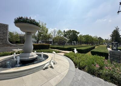 Elegant outdoor garden with fountain and manicured landscaping