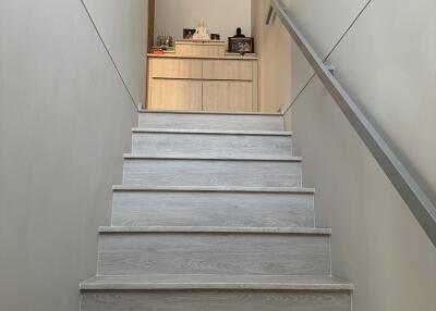Modern staircase ascending to an open kitchen area