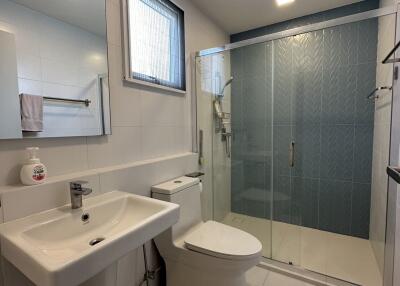 Modern bathroom with glass shower and white fixtures
