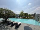 Luxurious outdoor swimming pool with lounge area and landscaped gardens