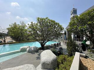 Luxurious outdoor pool area with lush landscaping and stylish building architecture