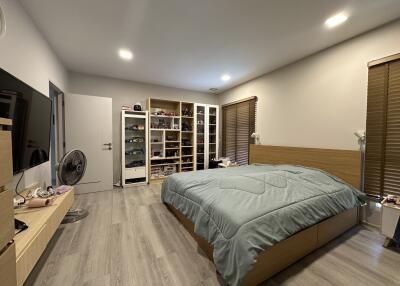 Spacious and well-lit bedroom with modern furniture