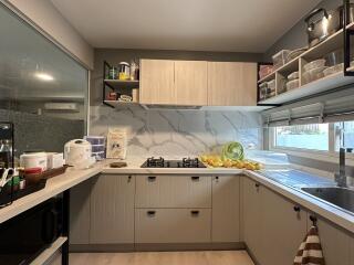 Modern kitchen with marble countertops and well-organized cabinetry