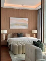 Elegant bedroom with stylish interior design, including a comfortable bed, plush seating, and ambient lighting