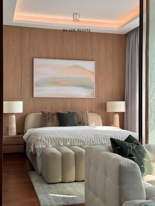 Elegant bedroom with stylish interior design, including a comfortable bed, plush seating, and ambient lighting