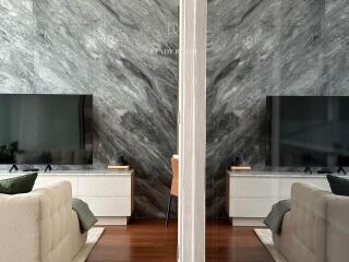 Elegant living room with marble wall and modern furnishings