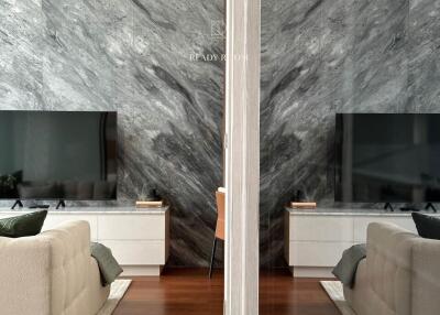 Elegant living room with marble wall and modern furnishings