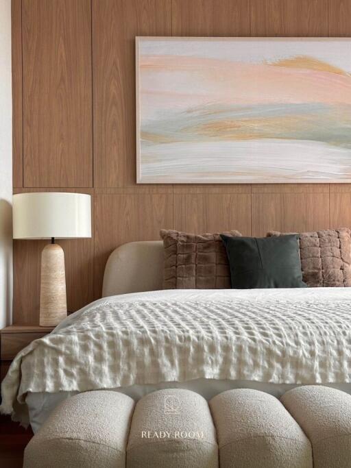 Elegant bedroom with wooden wall paneling and contemporary art