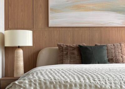 Elegant bedroom with wooden wall paneling and contemporary art