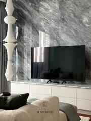 Modern living room with marble wall and large TV