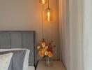 Cozy Bedroom Corner with Elegant Bedside Lighting and Flowers