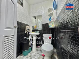 Compact bathroom interior with toilet and sink