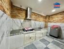 Modern kitchen with marble counters and brick walls