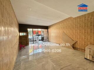 Spacious living room with ceramic tiled flooring and wooden wall paneling