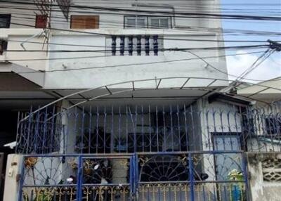 Three-story residential building with blue gate