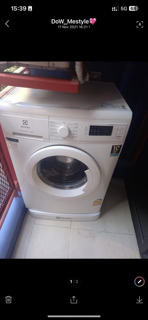 Modern washing machine in a compact laundry area