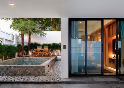 Luxurious outdoor area with swimming pool and modern seating by the house