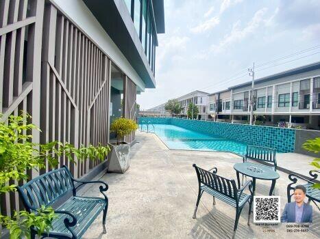 Inviting pool area with seating and residential units