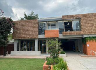 Modern two-story house with unique wooden and brick facade