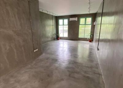 Spacious empty room with modern concrete walls and flooring