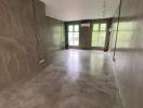 Spacious empty room with modern concrete walls and flooring