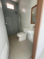 Modern bathroom with shower, toilet, and bidet