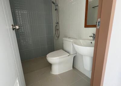 Modern bathroom with shower, toilet, and bidet
