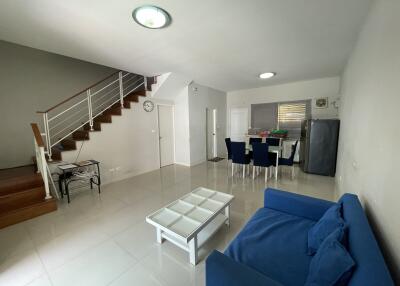 Spacious living room with modern staircase and ample natural light