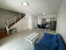 Spacious living room with modern staircase and ample natural light