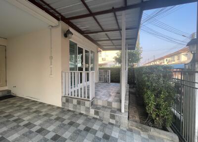 Spacious tiled patio with covered area and garden view