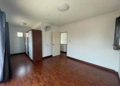 Spacious living room with hardwood flooring and ample natural light