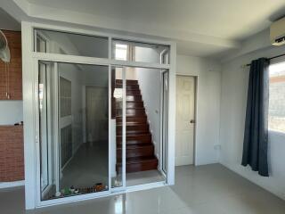 Spacious living room with staircase and balcony access