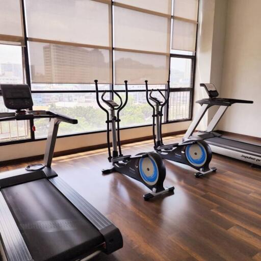 Spacious home gym with large windows and modern equipment