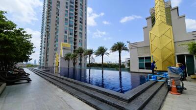 Modern outdoor swimming pool between high-rise buildings