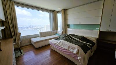 Spacious bedroom with large window and river view