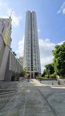 Tall residential skyscraper with a clear blue sky