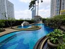 Luxurious pool area with lush greenery and modern sculpture surrounded by high-rise buildings